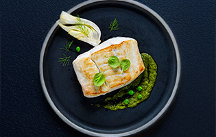 Pan fried Norwegian halibut with baked fennel, fresh peas and haricot verts sauté and chimichurri