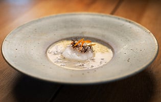 Baked Norwegian skrei with sago porridge and a sauce of truffle seaweed